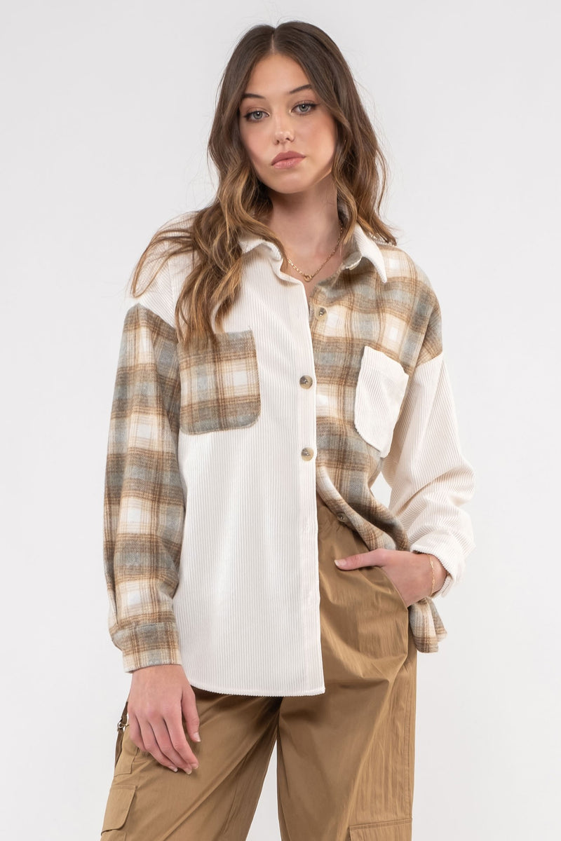 model wearing a cream and contrasting plaid button down shacket.