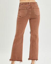 model wearing brown distressed jeans