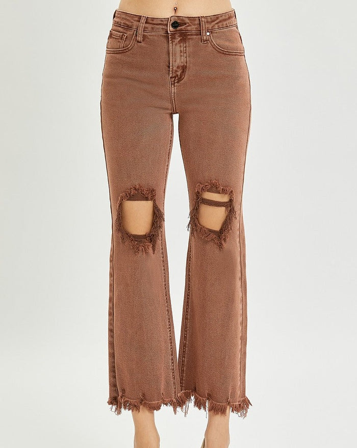 model wearing brown distressed jeans
