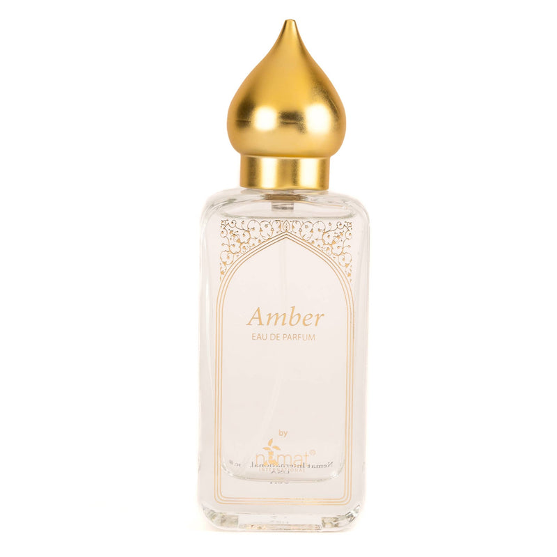 Clear glass perfume bottle with a gold teardrop lid. Reads "Amber Eau de parfum by nemat" on the front