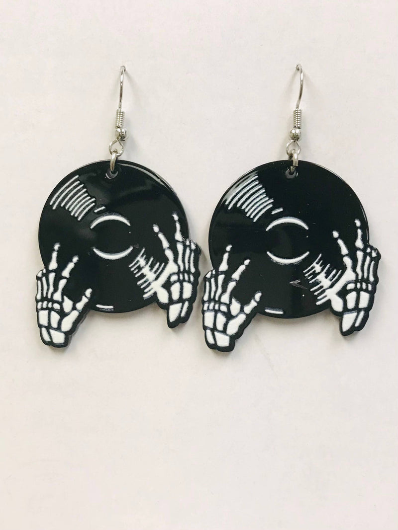 black vinyl record earrings with skeleton hands