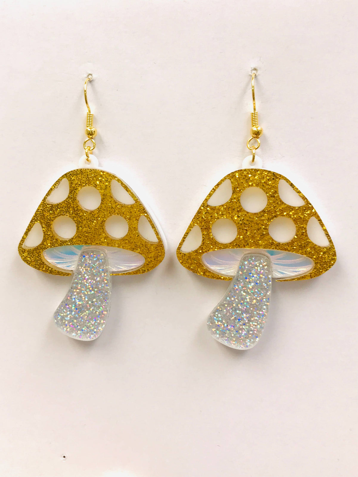 golden acrylic mushroom earrings with sparkles