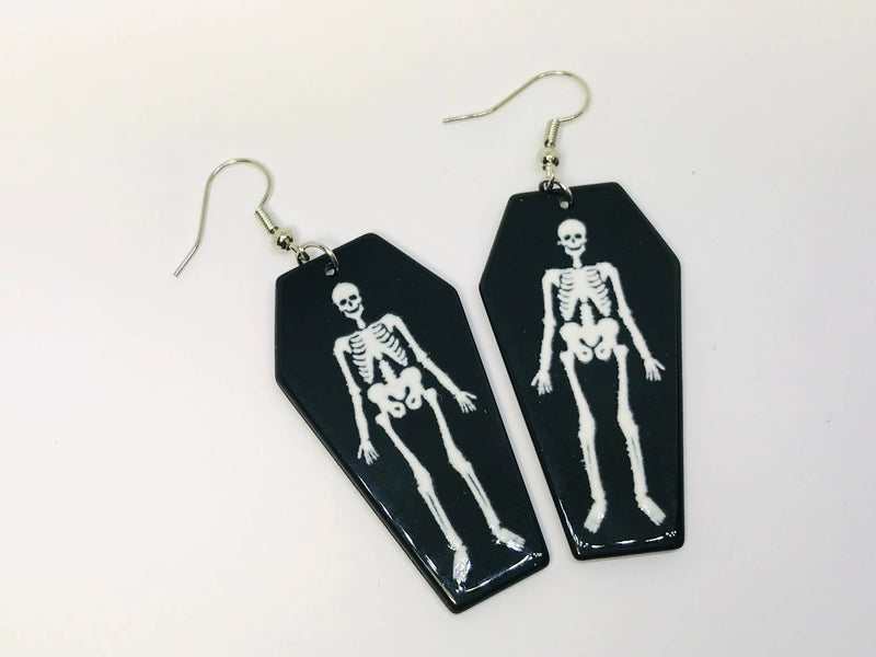 black acrylic coffin earings with skeletons inside them